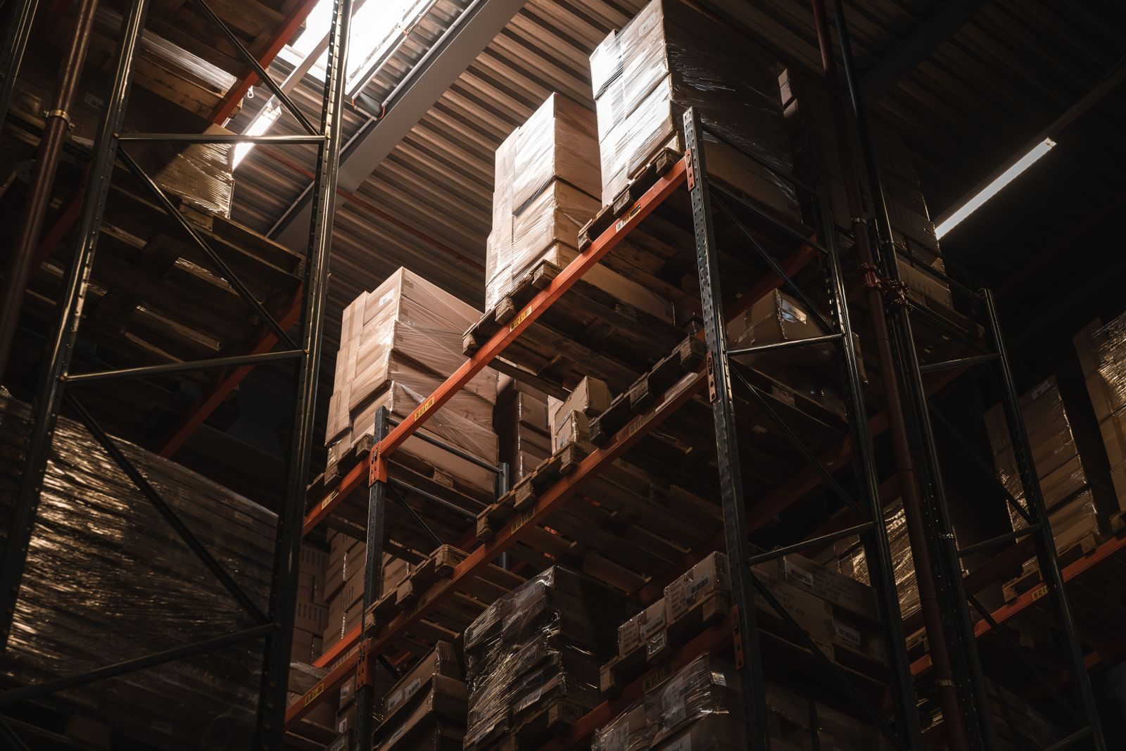 Shrink-wrapped pallets stacked on warehouse racking