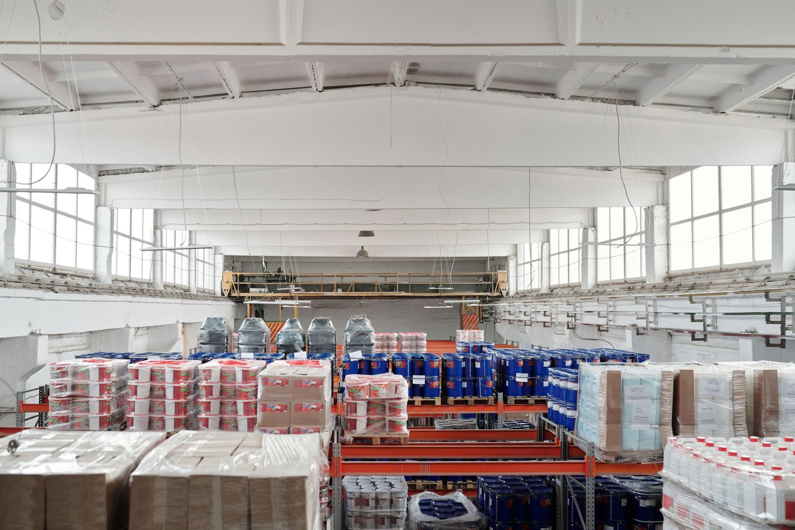 Palletized freight and boxed goods staged on warehouse racking